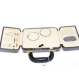 Travel jewellery box with contents including gold and silver.