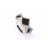 14 carat white gold black diamond trilogy ring featuring three square cut black diamonds,