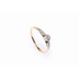 18 carat yellow gold and platinum diamond ring featuring one round brilliant cut diamond,