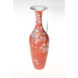 Chinese vase with raised blossom decoration on matt red ground, marked to base, 26cm.