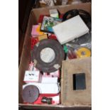 Box with vintage projector, slides and film reels.