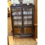 Edwardian mahogany vitrine having two glazed panel doors with two fall front doors below on square