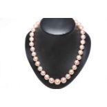 Pearl necklace featuring thirty five round cultured Akoya pearls with 14 carat rose gold clasp and