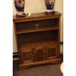 Carved oak two door open bookcase.