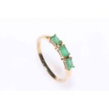 9 carat gold three stone emerald ring, size X.