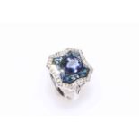 18 carat white gold tanzanite, sapphire and diamond ring featuring one oval cut tanzanite,