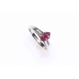 18k white gold oval ruby ring with diamond set shoulders, size K.