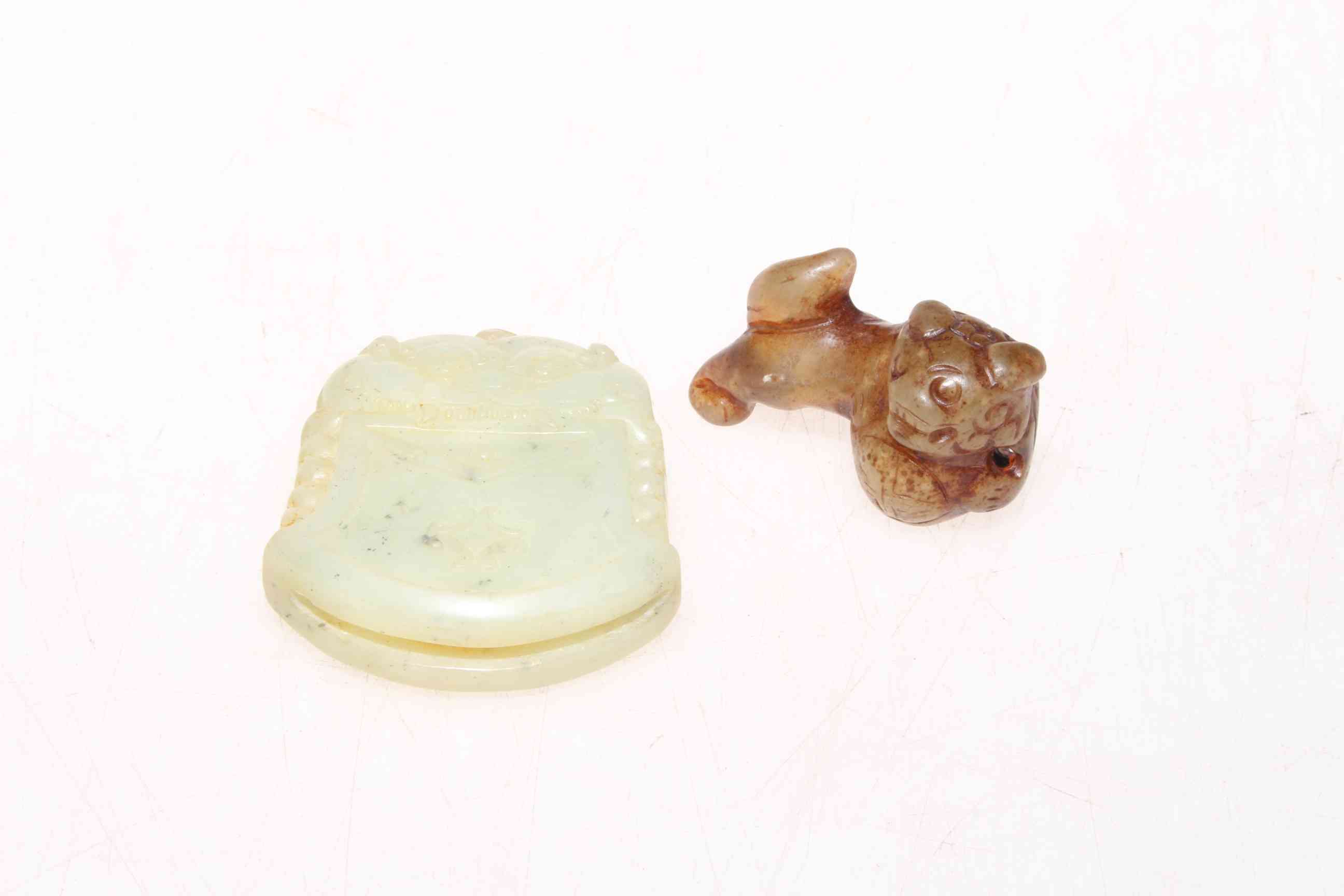 Small jade dog of fo and a jade dragon amulet (2).