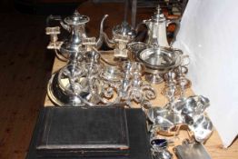 Collection of silver plate including teapots, candle holders and tureen.