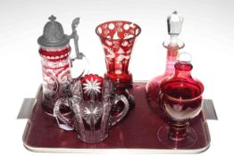 Five pieces of cranberry glass including decanter and vase.