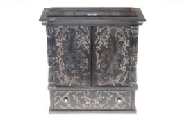 Small ebonised cabinet with floral inlay, 37cm by 36cm.