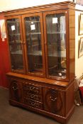 Mahogany finish display cabinet having three glazed doors above a base of three drawers flanked by