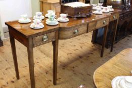 Georgian mahogany bow front serving table having four frieze drawers raised on six square tapering