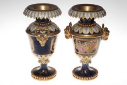 Pair of navy and gilt two handled vases decorated with floral panels, stamped 'M' underneath, 36cm.