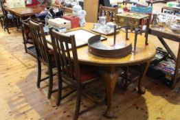 Oval oak extending dining table and four oak dining chairs.