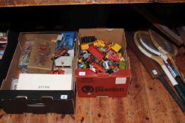 Two boxes of Diecast toy cars, playing cards, skittles, and tennis rackets.