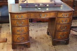 Mahogany serpentine front kneehole desk with green inset leather top raise don bracket feet,