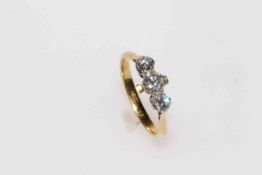 18 carat gold three stone diamond ring, total approximately 0.8 carat, size N/O.