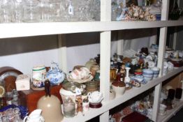 Shelf of ceramics, mantel clock, glass.