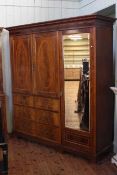 Large Victorian mahogany wardrobe having mirrored door hanging section beside a double cupboard