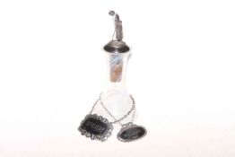Lady golfer mounted bottle and two silver labels, 18cm.