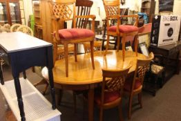 Continental oval extending dining table and six lattice back chairs including pair carvers.