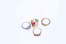 Collection of five gold gem set rings including emeralds.