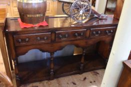 Oak potboard dresser having three frieze drawers raised on turned legs, 141cm by 43cm.