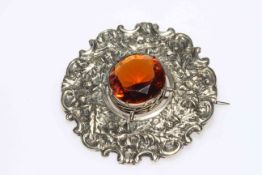 Large Scottish silver Cairngorn brooch, having centre stone set in ornate thistle and scroll mount.