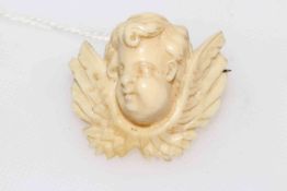 Ivory winged cherub brooch.