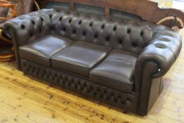 Brown deep buttoned leather Chesterfield three seater settee.