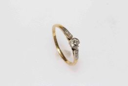 18 carat yellow gold and platinum diamond ring featuring one round brilliant cut diamond,