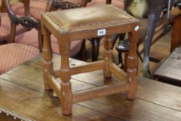 Sid Pollard small oak stool with leather top raised on four turned leg to understretchers,