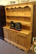 Pine kitchen dresser with shelf and four spice drawer rack above a base with three drawers and