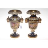 Pair of navy and gilt two handled vases decorated with floral panels stamped M to the base.