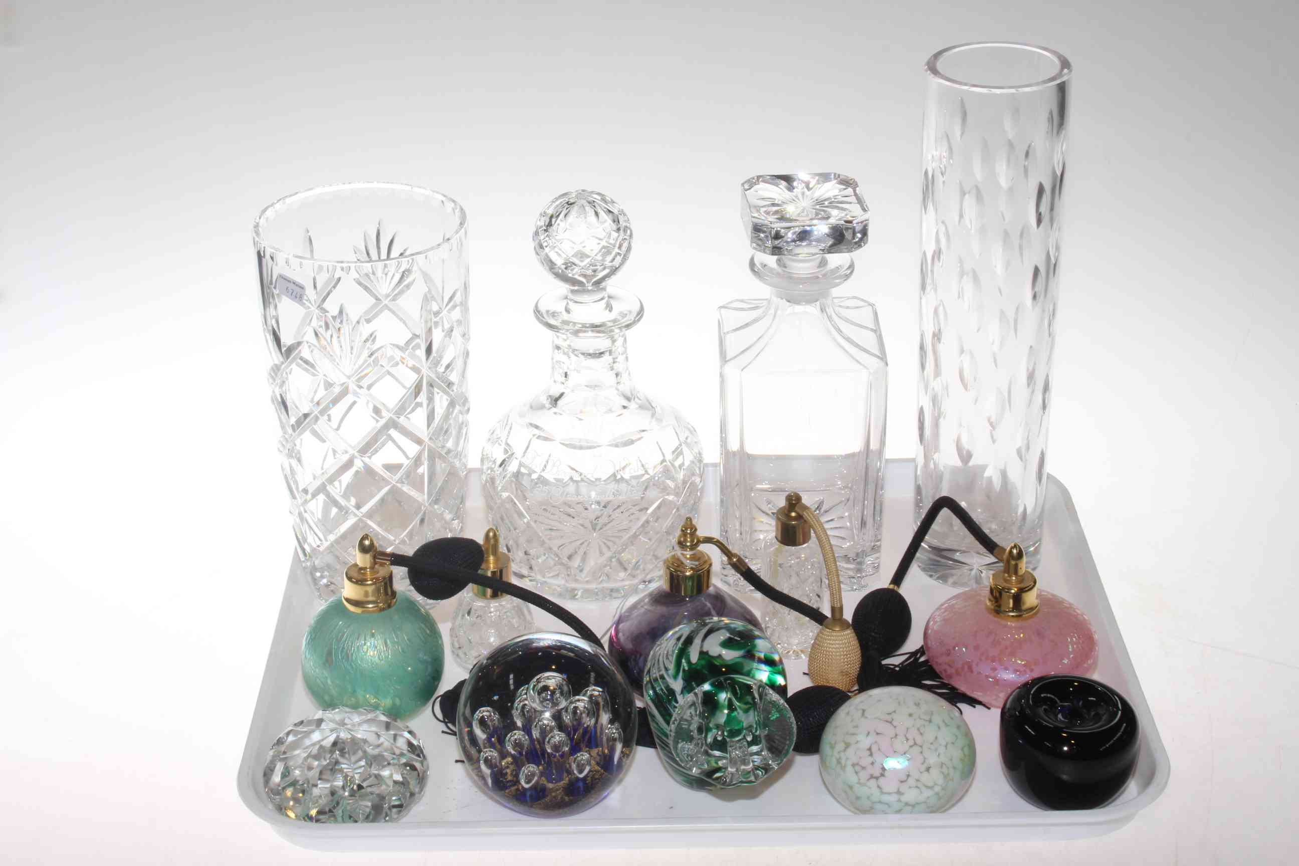 Crystal decanters, vases and coloured glass scent bottles and paperweights.