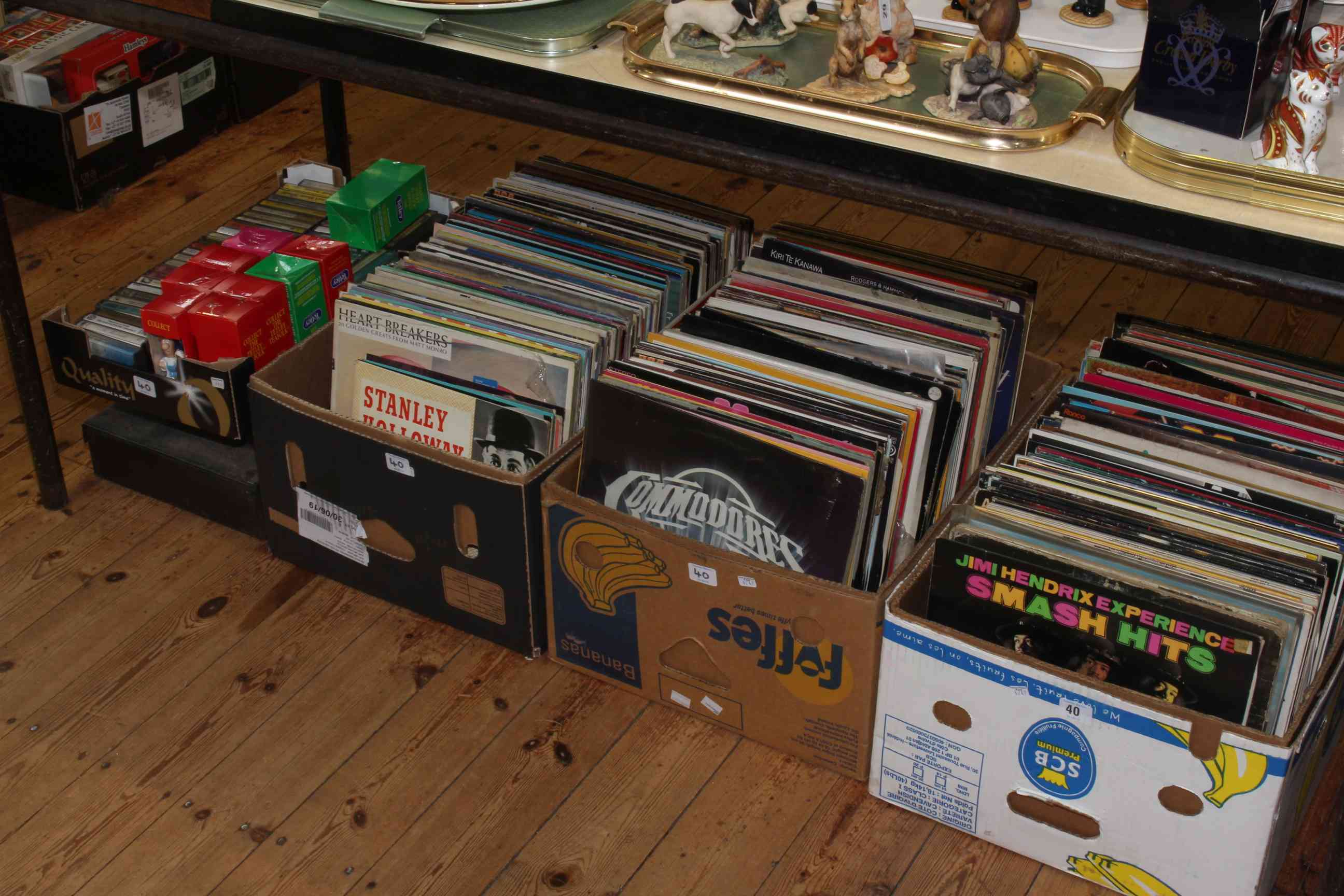 Three boxes of LP records, box and two cases with cassettes and Tetley figures.