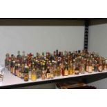 Shelf of assorted spirit miniatures including Whisky, Gin, Amaretto, etc.