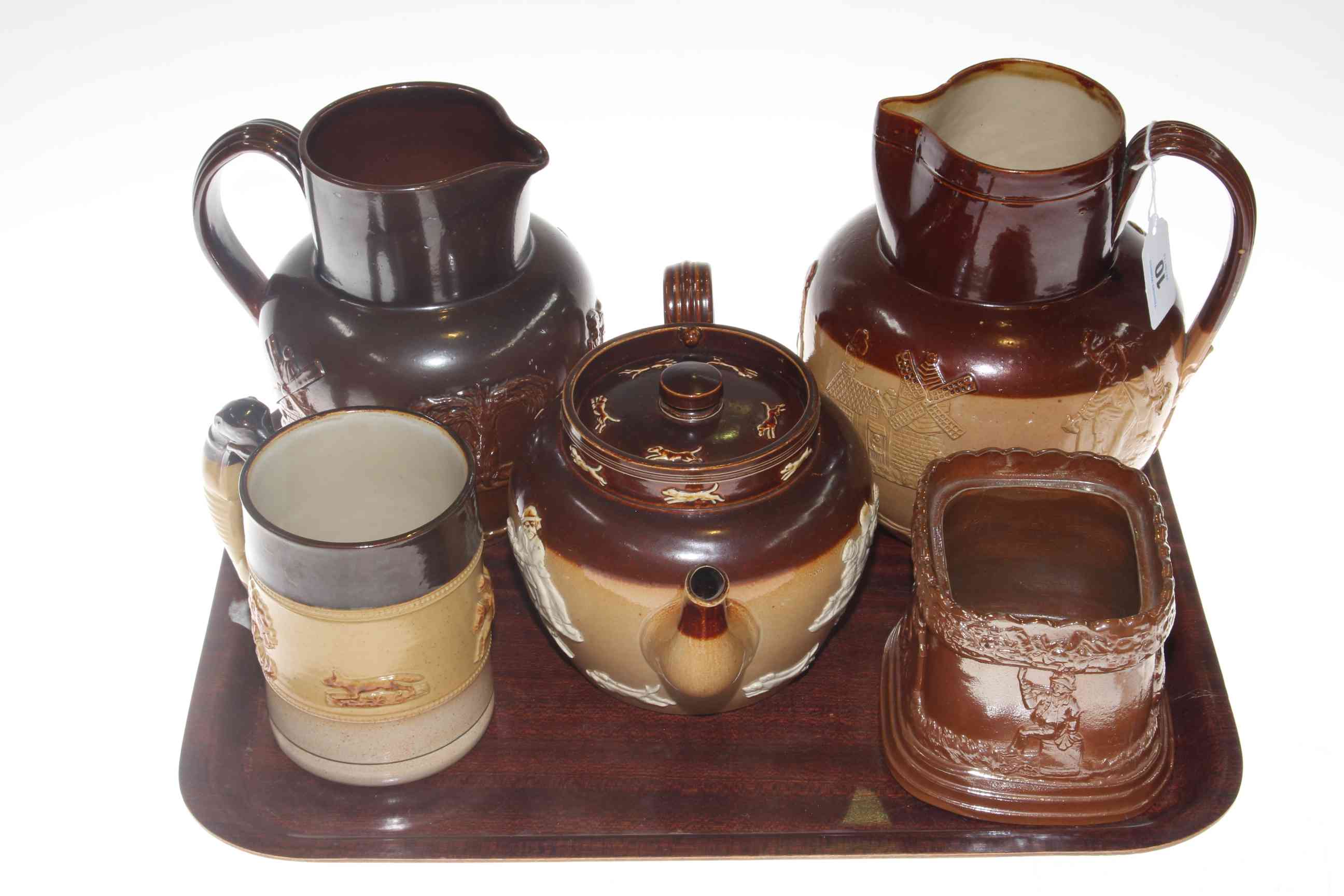 Five pieces of Doulton and other brown stoneware.