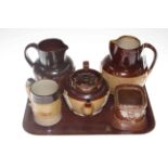 Five pieces of Doulton and other brown stoneware.