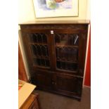 Oak linen fold panel four door cabinet bookcase.