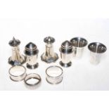 Two pairs of silver condiments, three silver napkin rings and pair tot cups (9).