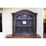 19th Century carved oak arched top glazed panel wall cupboard with canted corners, 88cm by 92cm.