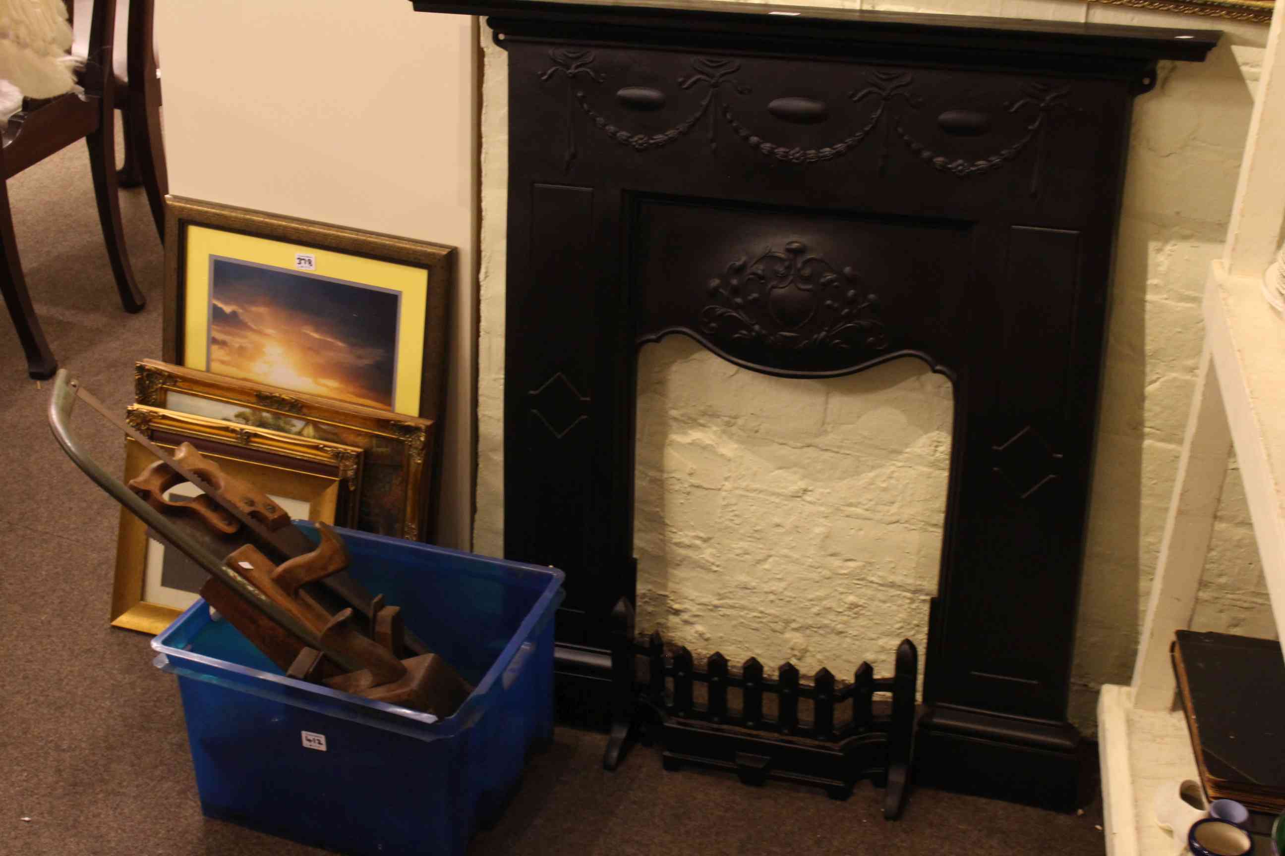 Cast iron fireplace and collection of hand tools including planes.