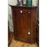 19th Century oak corner wall cupboard with arched panel door.