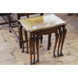 Burr walnut nest of three cabriole leg tables (largest 56cm by 58cm).