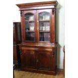 Victorian style mahogany cabinet bookcase having two glazed doors above two drawers with two