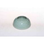 Chinese green celadon brush washer with sea scroll decoration, impressed mark, 11cm diameter.