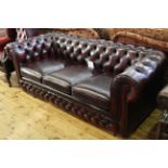 Ox blood deep buttoned leather three seater Chesterfield settee by Thomas Lloyd.