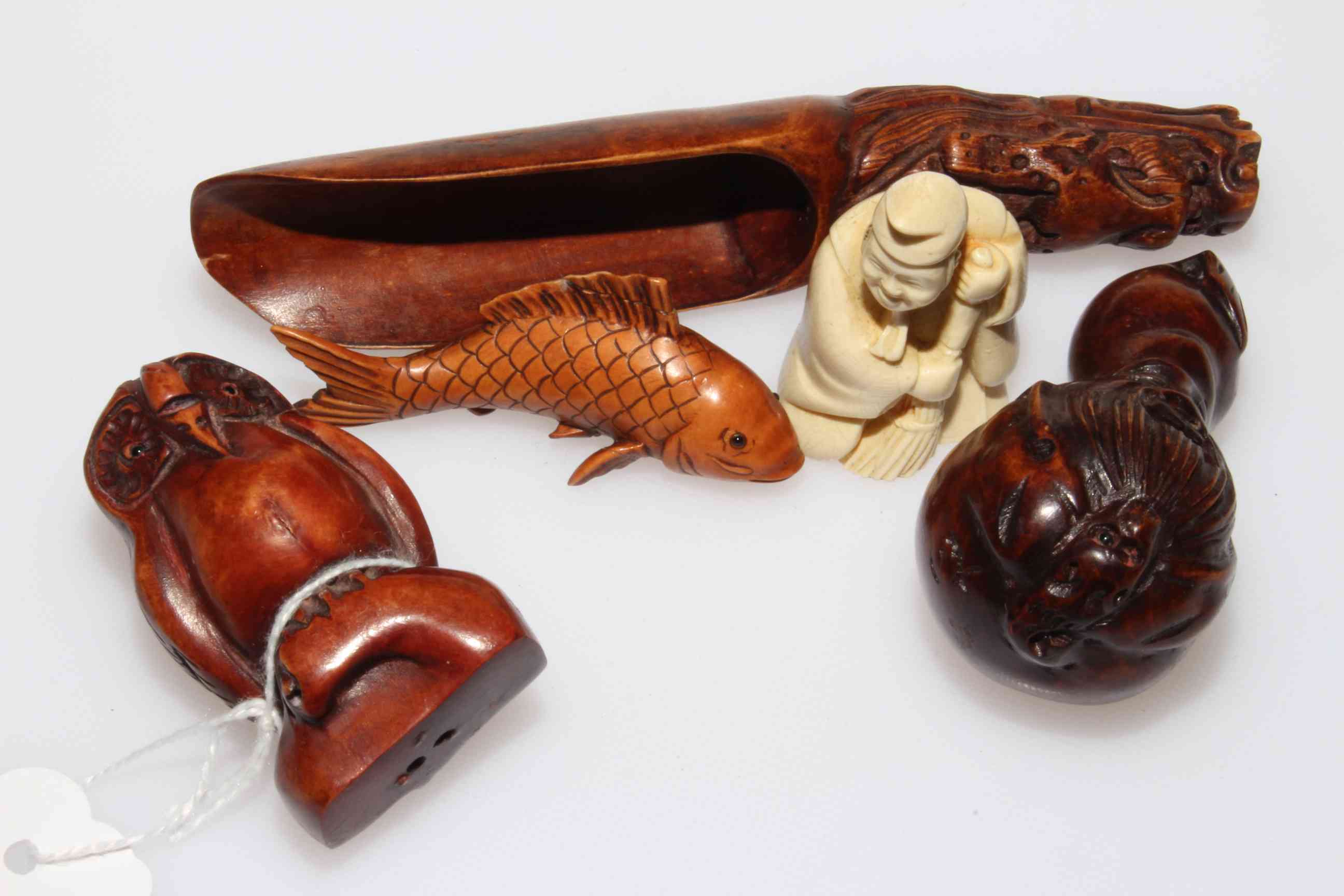 Three carved wood netsuke, owl, gourd with mask and carp; carved scoop and small figure (5).